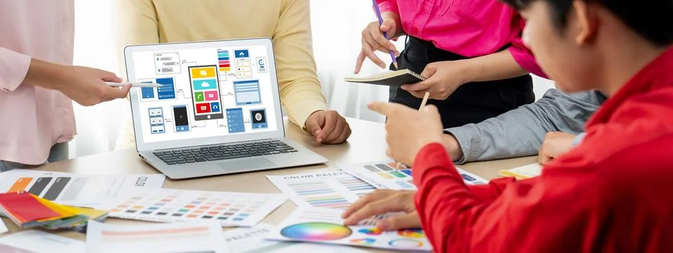 Designer team present color while laptop displayed UI and UX designs Variegated. Foto stock