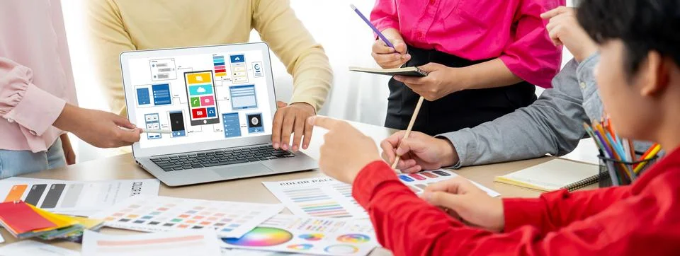 Designer team present color while laptop displayed UI and UX designs Variegated. Foto stock