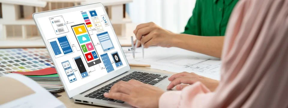 Designer team present color while laptop displayed UI and UX designs Variegated. Stock Photos