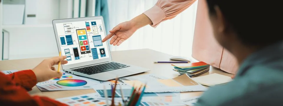 Designer team present color while laptop displayed UI and UX designs Variegated. Foto stock