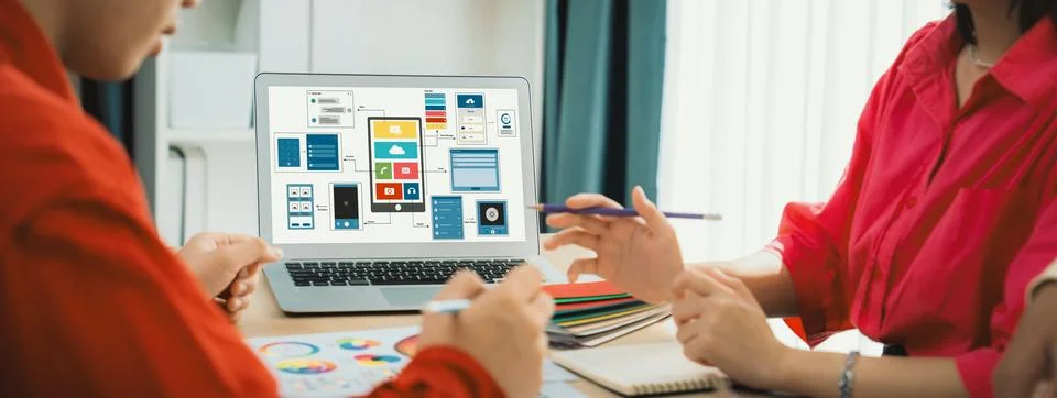 Designer team present color while laptop displayed UI and UX designs Variegated. Foto stock