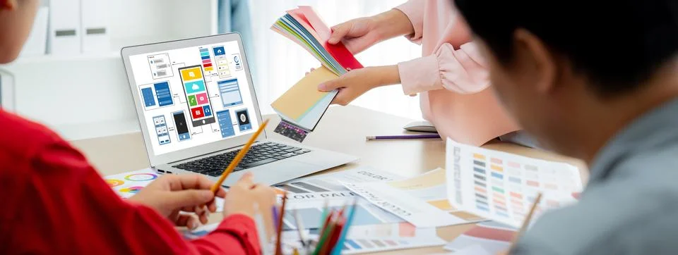 Designer team present color while laptop displayed UI and UX designs Variegated. Foto stock