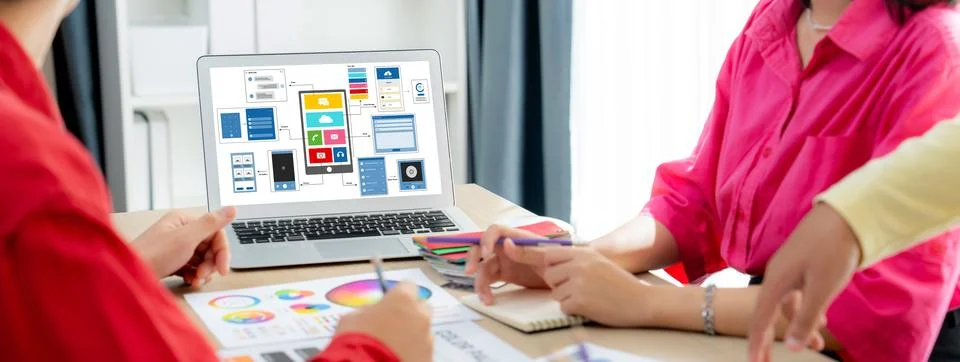 Designer team present color while laptop displayed UI and UX designs Variegated. Foto stock