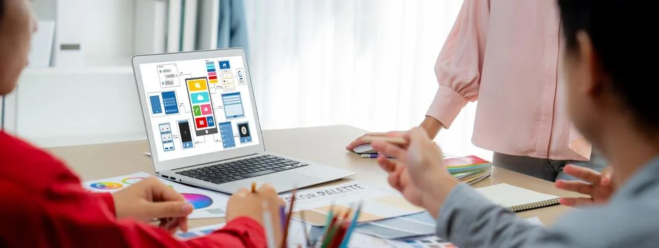 Designer team present color while laptop displayed UI and UX designs Variegated. Foto stock