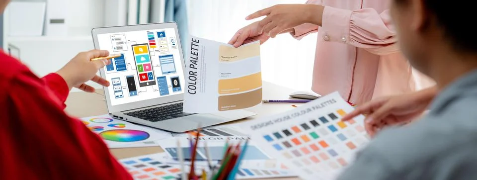 Designer team present color while laptop displayed UI and UX designs Variegated. Foto stock