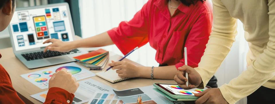 Designer team present color while laptop displayed UI and UX designs Variegated. Foto stock