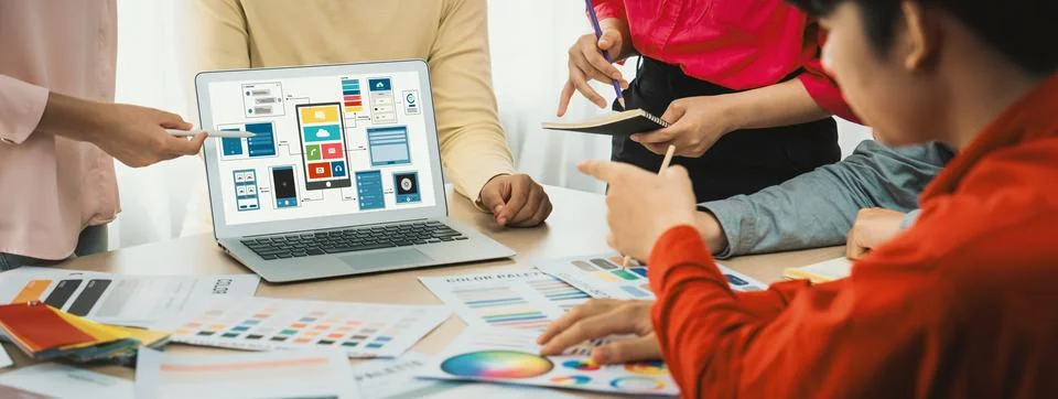 Designer team present color while laptop displayed UI and UX designs Variegated. Foto stock