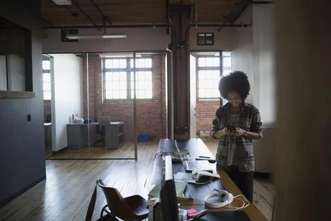 Designer texting in office Stock Photos