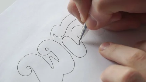 Designer trace the letters with pen Stock Footage 72221726