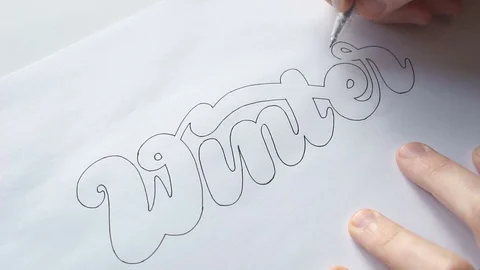 Designer trace the letters with pen Stock Footage 72221845