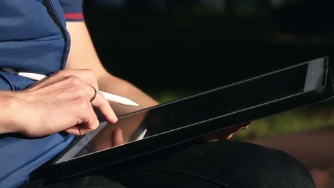 Designer typing message On Tablet at park Stock-Footage 82360541