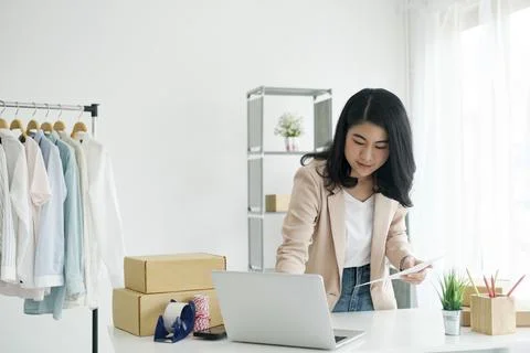 Designer using computer and drawing sketches for new collection Stock Photos