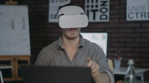 Designer wearing vr goggles. Programmer using vr glasses in dark office Stock Footage 111574179
