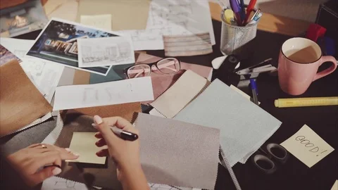 The designer work space she enumerate samples of the fabric of future furniture Stock Footage 73489058