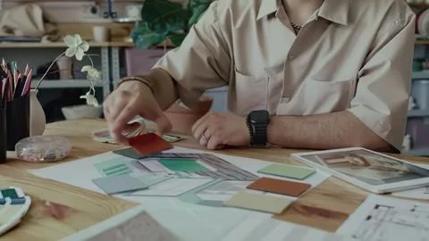 Designer working with color samples at desk in studio Stock Photos