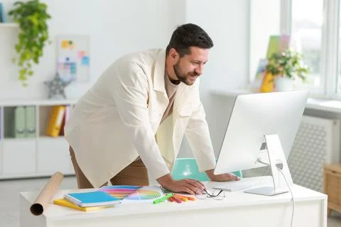 Designer working with computer at table in office Stock Photos