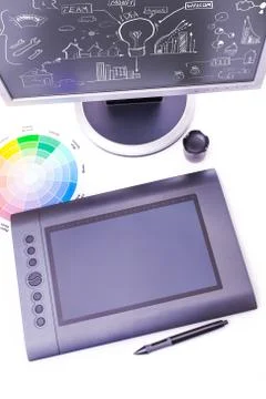 Designer working desk filled with computer,pen tablet Stock Photos