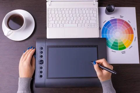 Designer working desk filled with computer,pen tablet Stock Photos