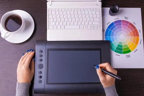 Designer working desk filled with computer,pen tablet Stock Photos
