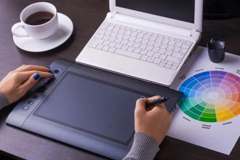 Designer working desk filled with computer,pen tablet Stock Photos