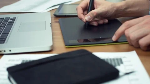 Designer working with graphics tablet, hands of man working with drawing tablet Stock Footage 81879979