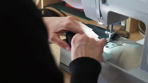 Designer working at home creates face masks as protection against viruses Stock Footage 127653482