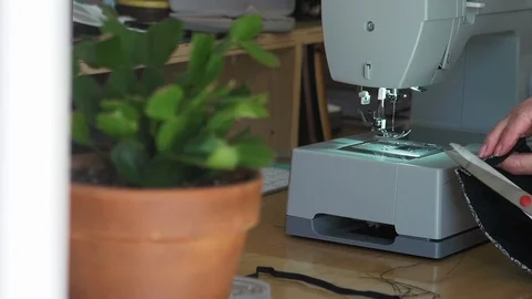 Designer working at home creates face masks as protection against  viruses Stock Footage 127655004