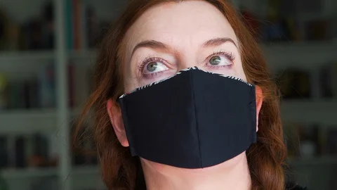 Designer working at home creates face masks as protection against viruses Stock Footage 127655680