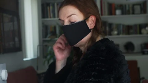Designer working at home creates face masks as protection against viruses Stock Footage 127657155