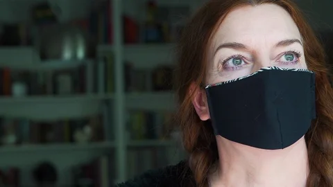 Designer working at home creates face masks as protection against viruses Stock Footage 127657397