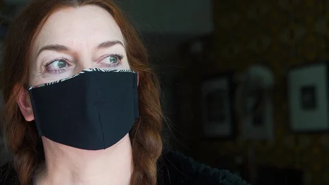 Designer working at home creates face masks as protection against viruses Stock Footage 127658116