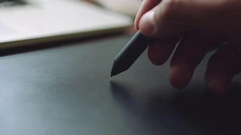 Designer working on a laptop with a graphics tablet. Stock Footage 76781418