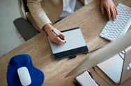 Designer Working On The Pen Table In Office Top View. Stock Photos