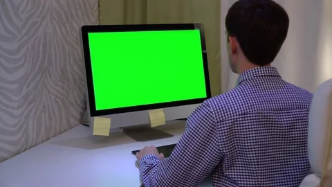 The designer works on a graphic tablet at the PC with chroma key green screen. 스톡 동영상 80968855