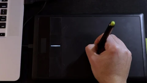 Designer works with graphics tablet and laptop. Top view Stock Footage 124878448