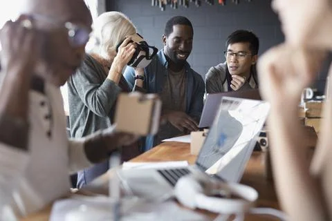 Designers and computer programmers testing and programming virtual reality simul Stock Photos