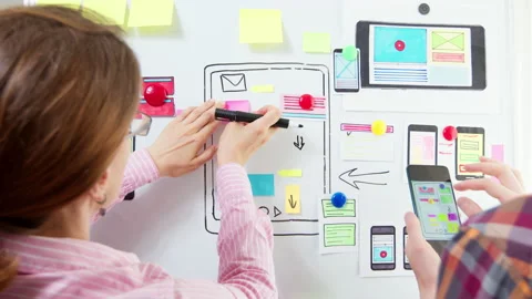 Designers are developing a web application for mobile phones. Stock Footage 156804999