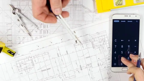 Designers are sitting at the table discussing the reconstruction of the store Stock-Footage 73676617