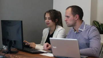 Designers collaborating on a project, working on computer in creative office Stock-Footage 85571363