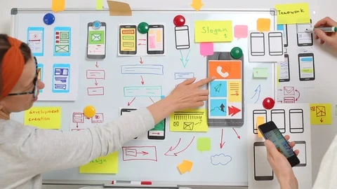 Designers create a user experience interface for smartphones.  Stock Footage 122392386