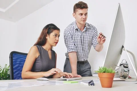 Designers discussing website interface Stock Photos