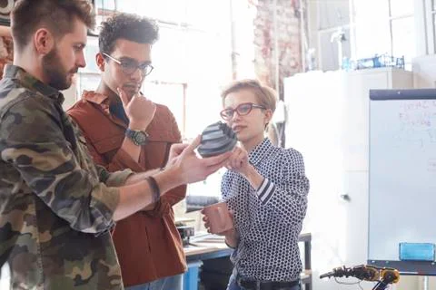 Designers meeting, examining prototype in workshop Stock Photos