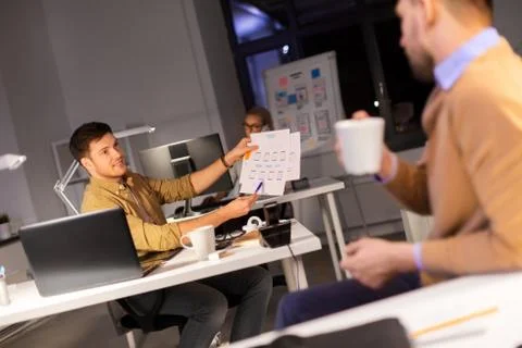 Designers or software developers at night office 스톡 사진