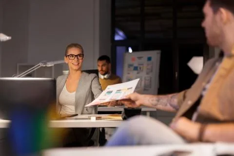 Designers or software developers at night office Stock Photos