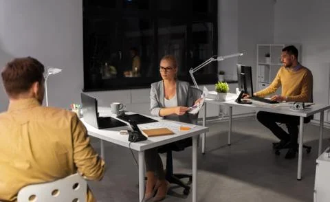 Designers or software developers at night office 스톡 사진