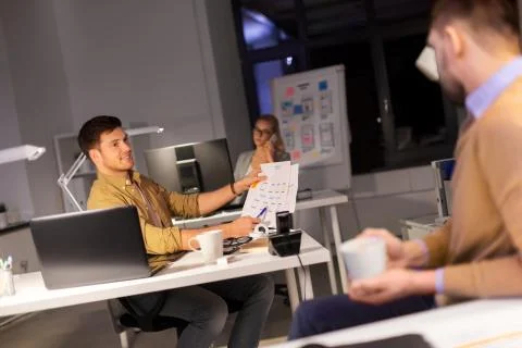Designers or software developers at night office 스톡 사진