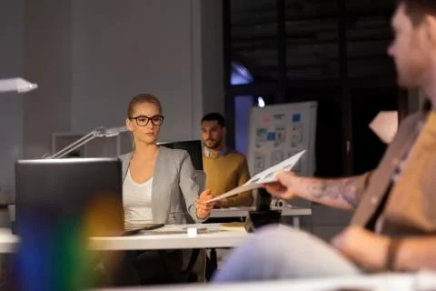 Designers or software developers at night office Stock Photos