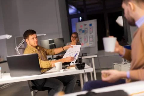 Designers or software developers at night office 스톡 사진