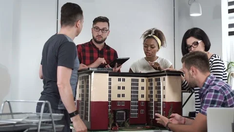 Designers working with mockup of house Stock Footage
