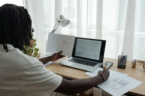 Designing User Interface on Laptop in Modern Workspace Stock Photos